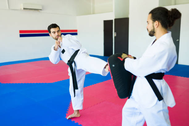 istock Young men training together taekwondo 1433470378