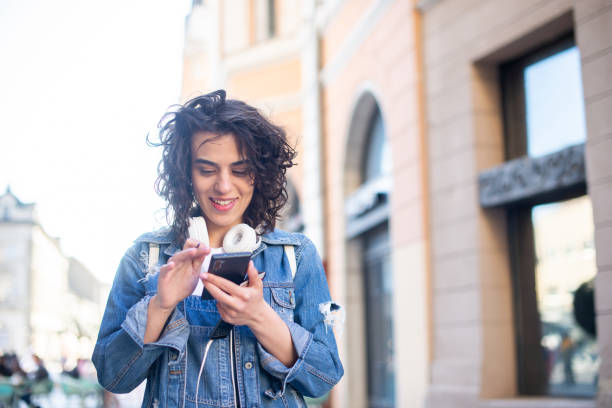 istock Happy young woman using phone 1433471001