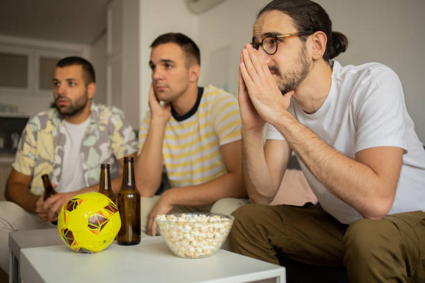 istock Friends together watching TV at home 1433471442