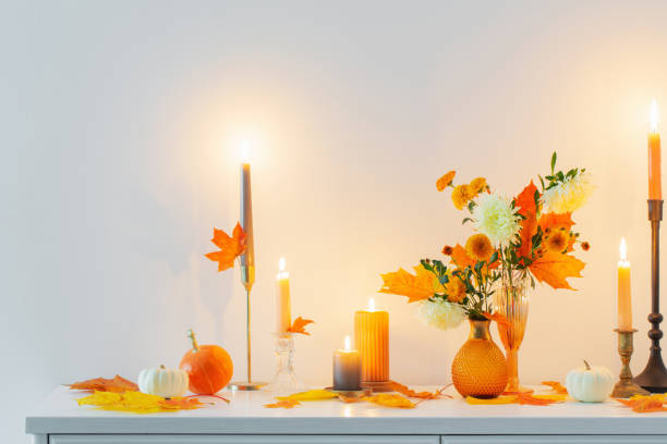 istock beautiful autumn home decor with burning candles in white interior 1433471972