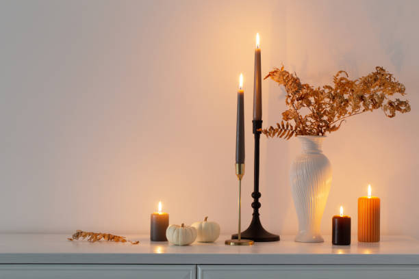 istock beautiful autumn home decor with burning candles in white interior 1433471982