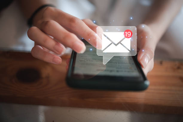 istock woman holding hand touchscreen smartphone and checking email icon online or sending mail to partner and customer on web with virtual interface technology concept. 1433472037