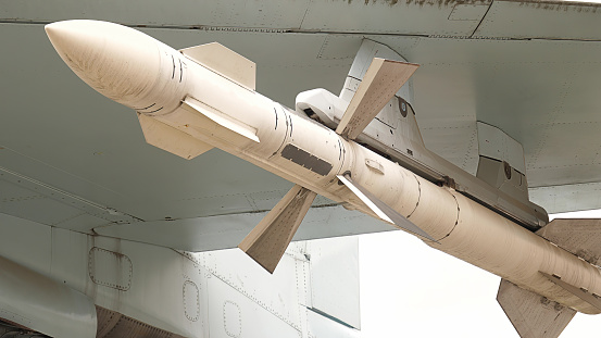 Detailed close up of an old English missile or rocket (RB68) nick named Bloodhound. On its launch ramp against a blue sky and brightly lit by the sun