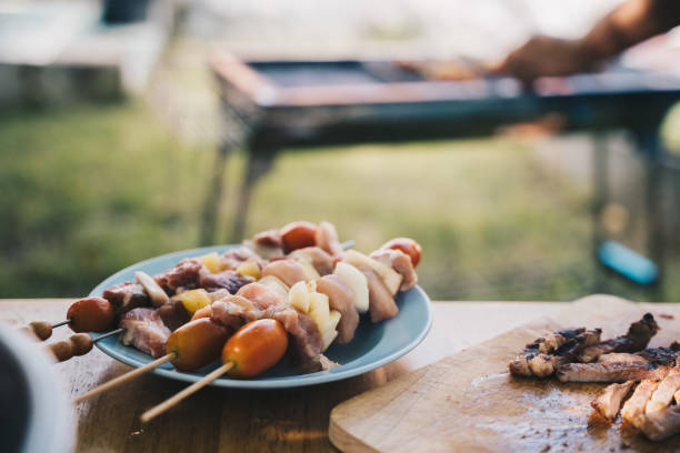 istock Friends making barbecue and having lunch in the nature. 1433481152