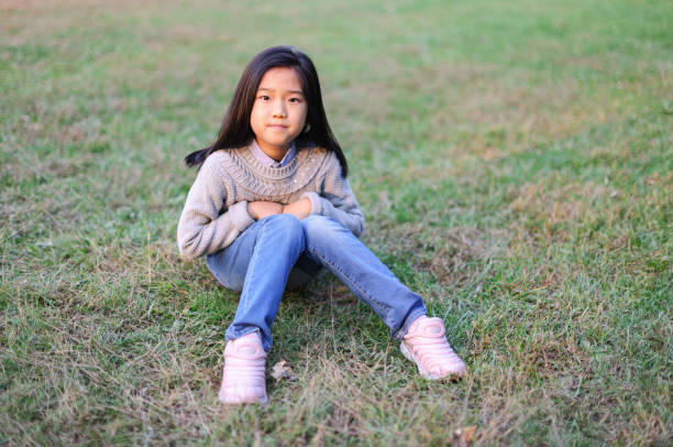 istock Little Girl Sitting on the Lawn 1433482030