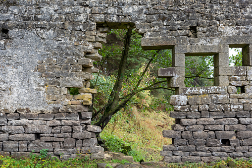 hole in wall of ruined old traditional building in Yorkshire, England, UK