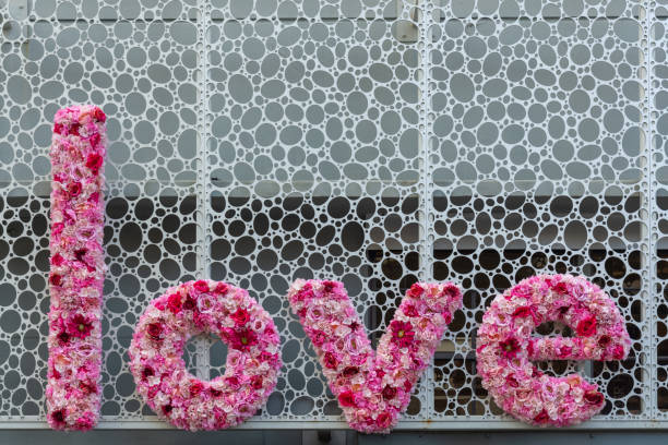 istock Love written in pink flowers as a sign. 1433489525
