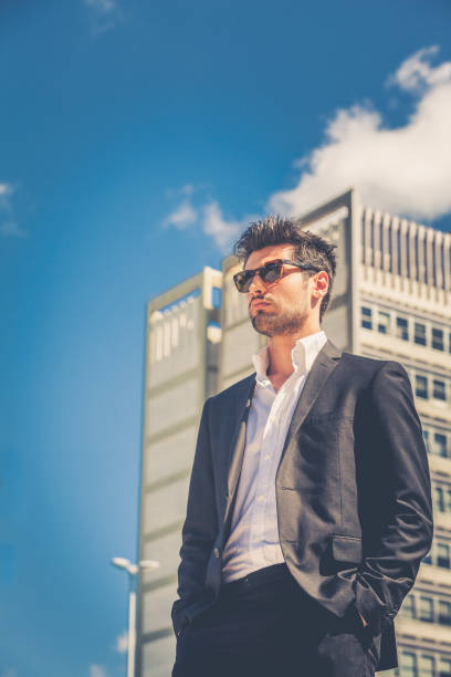 istock Confident handsome man with sunglasses standing outdoor, building behind. 1433489620