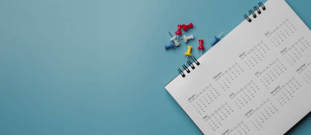 istock Embroidered red pins on a calendar event Planner calendar,clock to set timetable organize schedule,planning for business meeting or travel planning concept. 1433489774