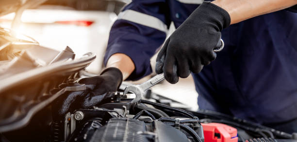 istock Car care maintenance and servicing, Close-up hand technician auto mechanic using the wrench to repairing change spare part car engine problem and insurance service support. 1433490203