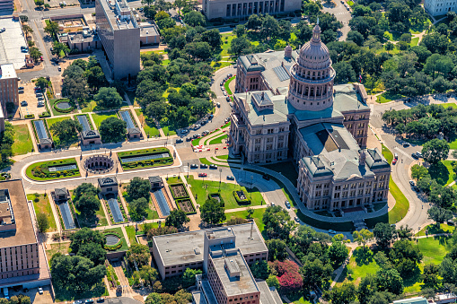 Aerial view of the iconic Texas State Capitol Building located in Austin, Texas shot from an altitude of approximately 1000 feet over the city.