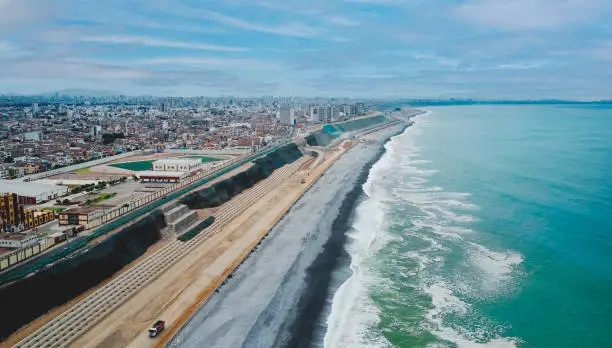 Photo of Lima, Peru. October, 2022. Aerial view of construction of highway Costa Verde, La Perla district, road on the beach.