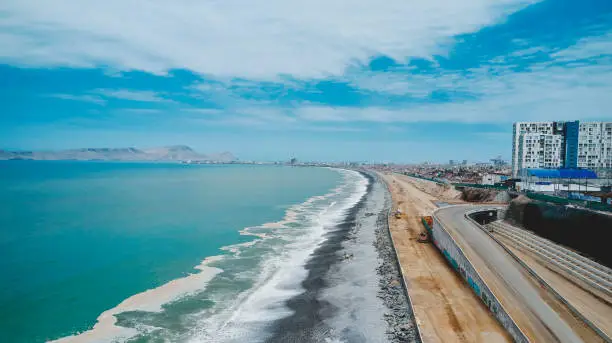 Photo of Lima, Peru. October, 2022. Aerial view of construction of highway Costa Verde, La Perla district, road on the beach.