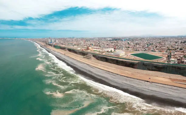 Photo of Lima, Peru. October, 2022. Aerial view of construction of highway Costa Verde, La Perla district, road on the beach.