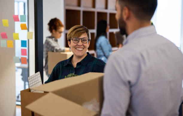 istock Happy group of workers moving into a new office 1433501532