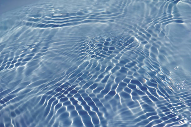 istock Defocus blurred transparent blue colored clear calm water surface texture with splash, bubble. Shining blue water ripple background. Surface of water in swimming pool. Blue bubble water shining. 1433503832