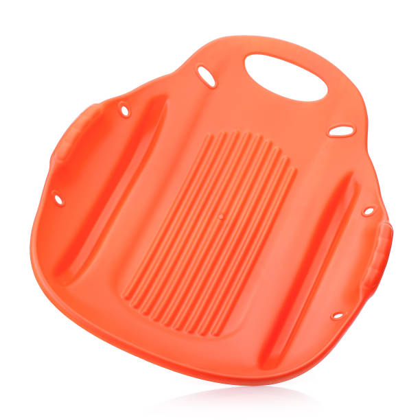 istock Children's plastic orange sled isolated on a white background. Sleds for skiing downhill in winter. Children's toys. Slide board 1433506244