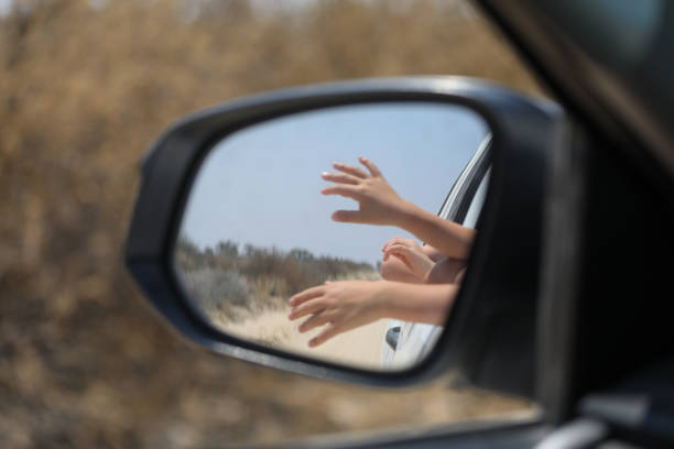istock Reflextion of hands in the car mirror. 1433508058