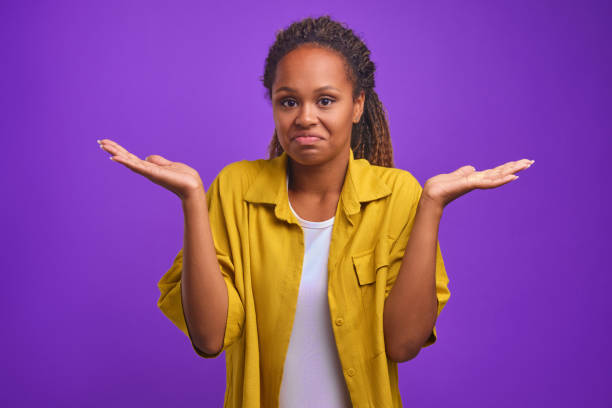 istock Young attractive African American woman throws up hands as sign uncomprehending 1433509149
