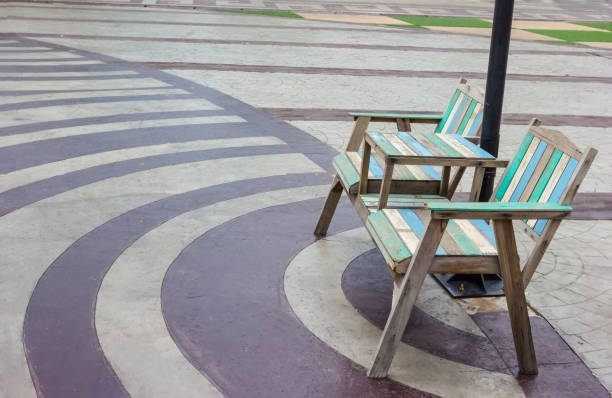 Old wooden chairs outdoors with bricks floor