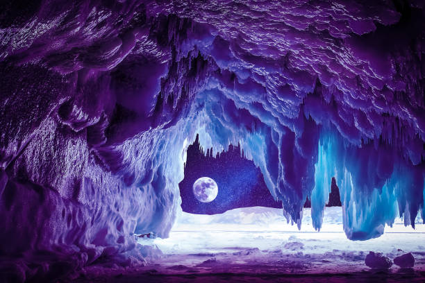 Ice cave. Winter violet landscape. Ice cave at moonlight.