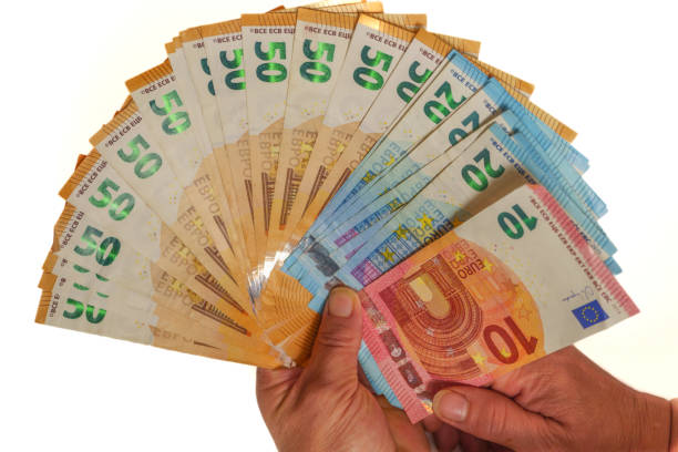 istock woman's hands holding fan-shaped euro banknotes 1433516652
