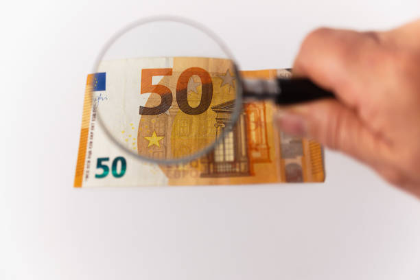 istock fifty euro banknote viewed with a magnifying glass 1433516682