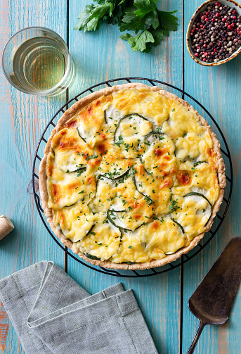 Pie with zucchini, cheese and herbs. Quiche. Vegetarian food.