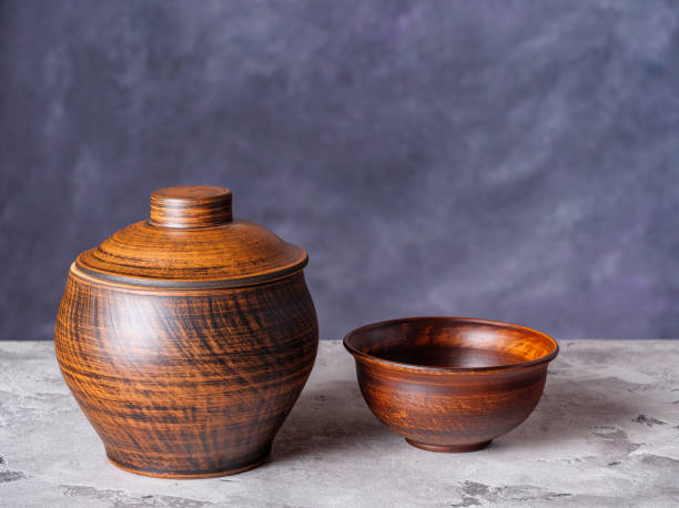 istock Clay pot and bowl on a rustic background 1433521378