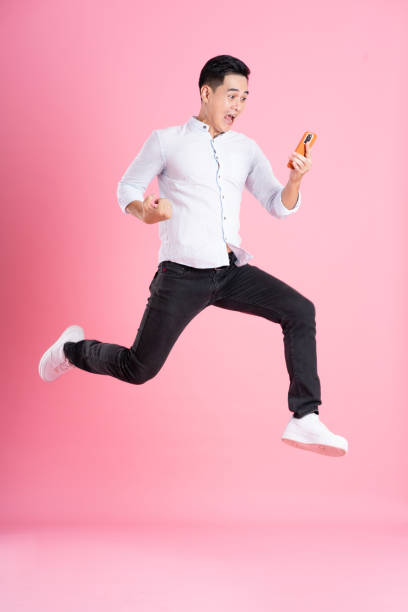 istock Asian man full body image, isolated on pink background 1433521465