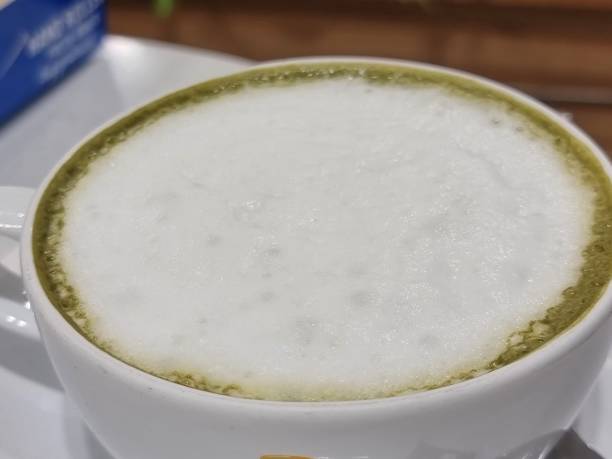 istock Green tea latte in a glass with white coasters. 1433521557