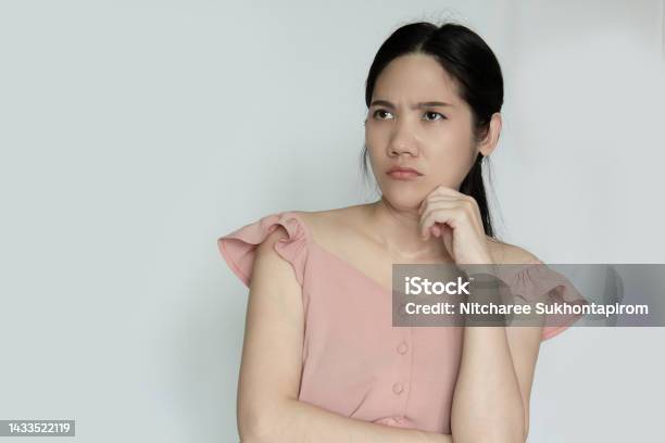 Asian Beautiful Woman Rise Chin On Hand With Thoughtful And Confusing And Question In Mind Stock Photo - Download Image Now
