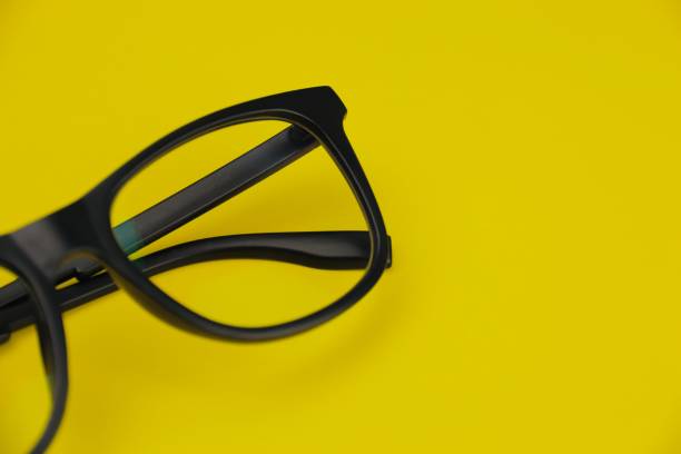 istock Closeup of eyeglasses frame on yellow background 1433522447