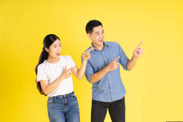 istock image of asian couple posing on yellow background 1433523294