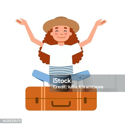 istock A girl in a hat is sitting on a suitcase in the lotus position. A person enjoys a vacation. 1433523473