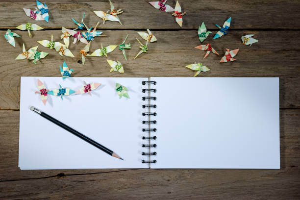 istock open note book with pencil on wood background 1433523498