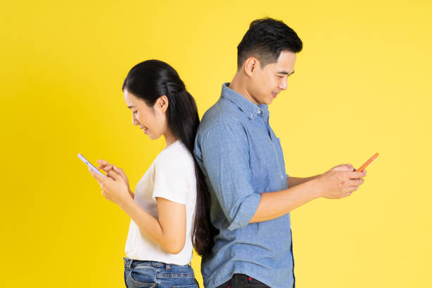 istock image of asian couple posing on yellow background 1433523677