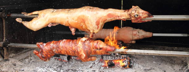 istock 2 lambs and a suckling pig on a charcoal grill 1433523998
