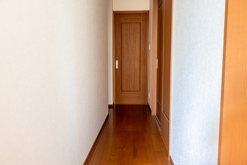 Narrow corridor with a sliding door at the end