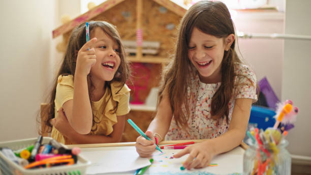 istock Sisters at home drawing and painting together 1433527784