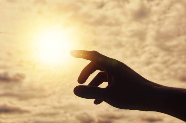 istock Hand reaching out to bright shining light. 1433529350