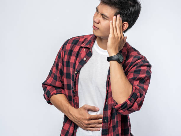istock A man who is sick and touches his head with his hand. 1433531674