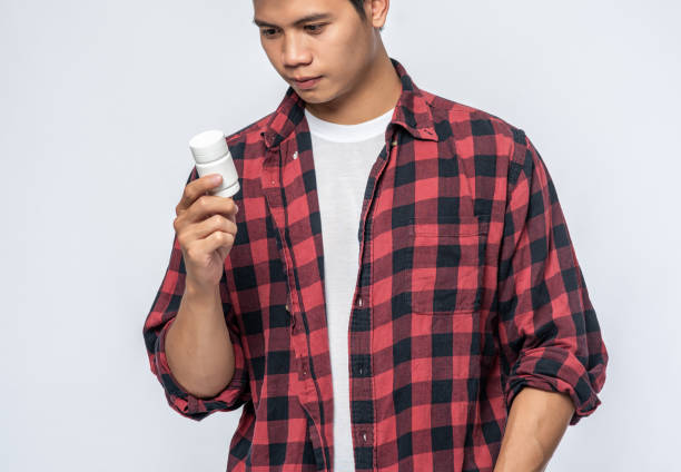 istock A man who is sick and carries a medicine bottle. 1433531902