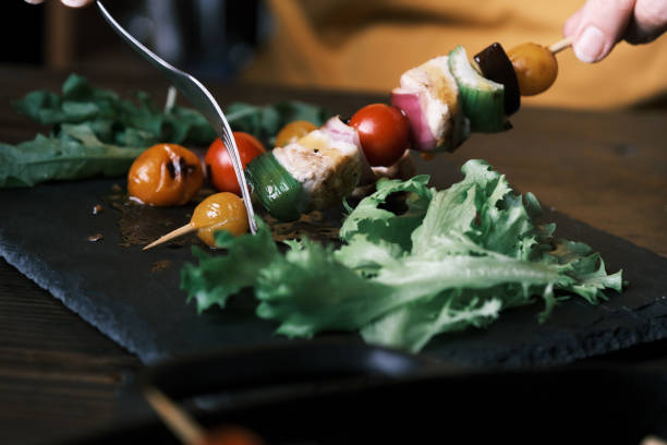 Close up photo of a couple of skewers on a tray