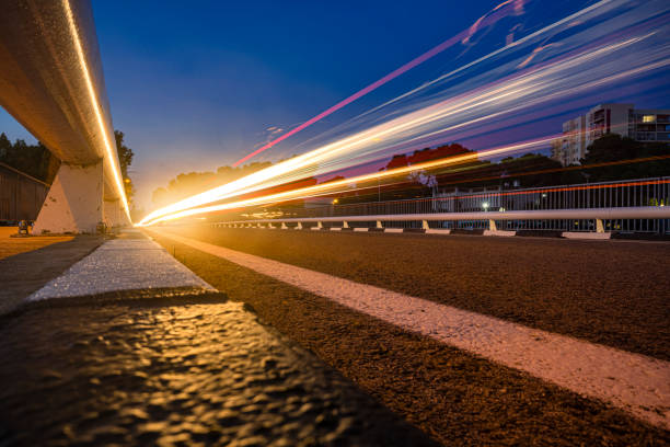 long exposure of car lights on the street at twilight - otono imagens e fotografias de stock