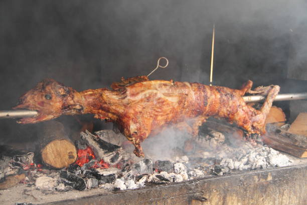 a lamb on a charcoal grill - roasted spit roasted roast pork barbecue grill imagens e fotografias de stock