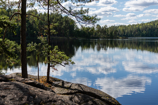Finnish lake view landscape in summer with the reflection on lake and clouds in the sky. Repovesi National Park in Kouvola