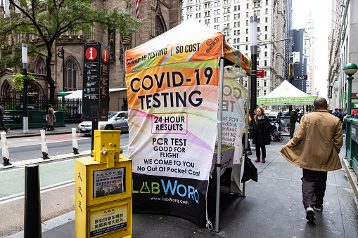 New York City, NY - October 5th 2022 : Covid-19 rapid antigen test in New York City lower Manhattan city streets. People walking on the sidewalk through the stalls