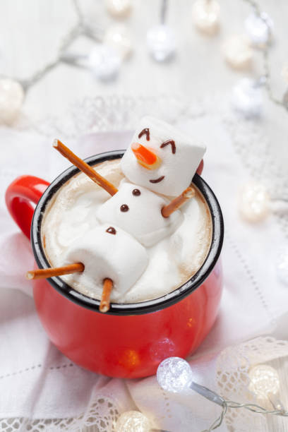 Hot chocolate with melted marshmallow snowman Red mug with hot chocolate with melted marshmallow snowman hot chocolate stock pictures, royalty-free photos & images