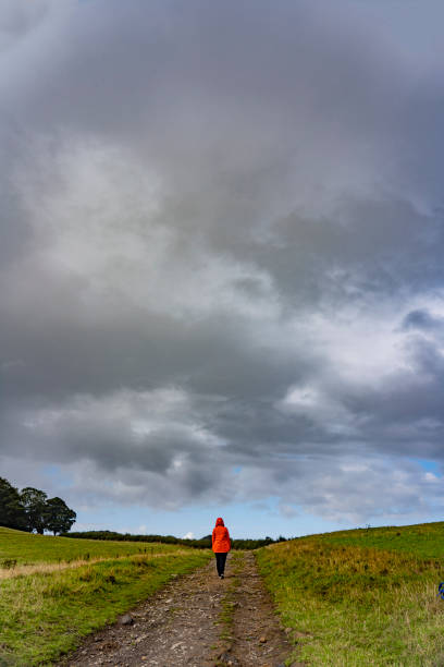 istock girl in orange coat walking along a track 1433541679